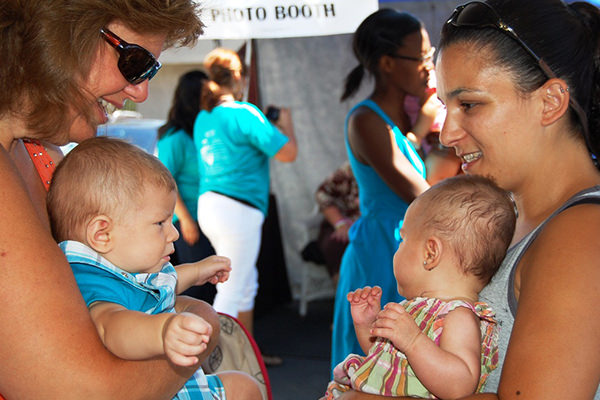 Two mothers holding their babies